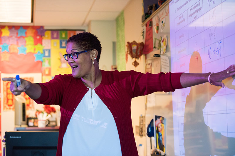 Classroom scene with a Sierra Canyon faculty member lecturing at the white board.